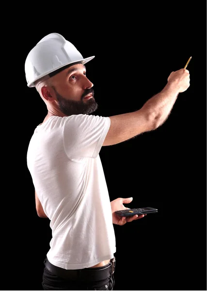 Young male construction worker pointing away with a pencil and looking up — Stock Photo, Image