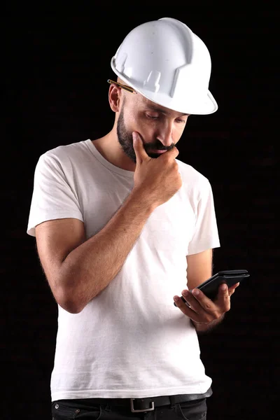 Competent young male construction worker thinking deeply — Stock Photo, Image