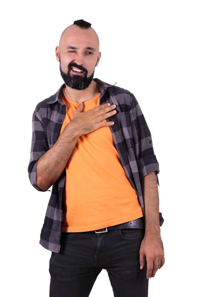 Seductive young man cheerfully winking with hand on his chest — Stock Photo, Image