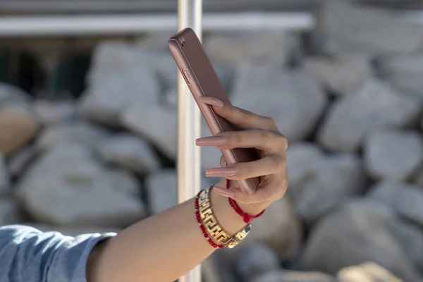 long nails woman taking a selfie on the boat on the sea background