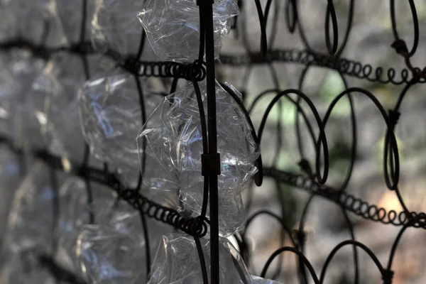 Many plastic bottle on grid — Stock Photo, Image