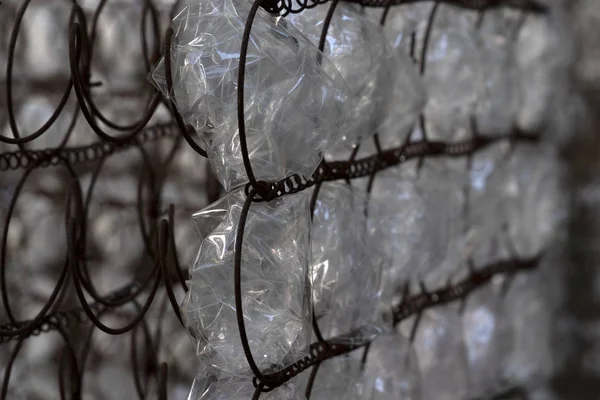 Many plastic bottle on grid — Stock Photo, Image