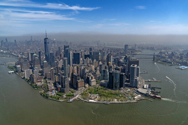 Manhattan aerial view from helicopter with fog on the back of the city