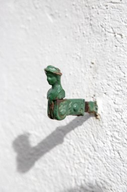 Beyaz duvar, klasik kepenkli salıncak, insan şeklinde.