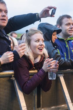 Traena, Norveç - 6 Temmuz 2017: Norveçli punk rock grubu Honningbarna'nın Traenafestival'deki konserinde seyirciler tezahürat, alkışlama ve dans etme, küçük Traena adasında düzenlenen müzik festivali