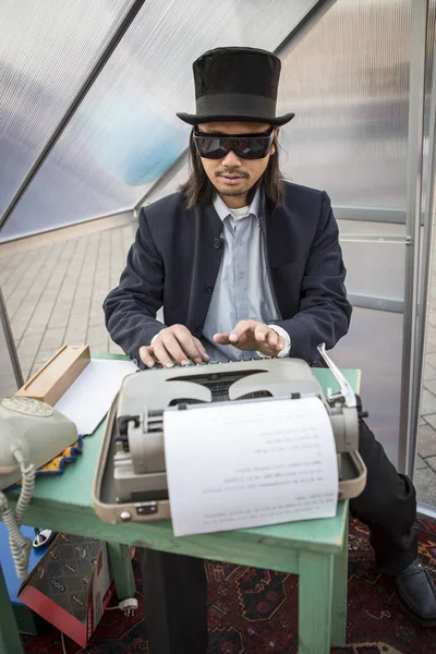 Amsterdam, The Netherlands, 12-14 Septembre 2014, during West'ival, an open air free Cinema and culture festival on Mercatorplein - artistic installation, man typewriting