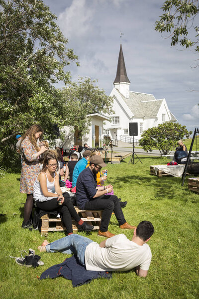 Traena, Norway - July 07 2016: people chilling out having a drink during Traenaf:, music festival taking place on the small island of Traena

