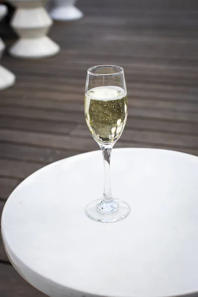 Glass of champagne on a lounge bar table