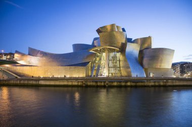 Bilbao, Spain - January 29, 2016: night view of modern and contemporary art Guggenheim Museum, designed by American architect Frank Gehry and inaugurated in October 1997. clipart