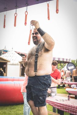 Amsterdam, The Netherlands - July 29 2017: man hanging plastic penisses at Milkshake Festival in Westerpark