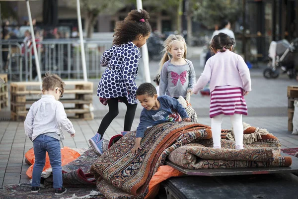 Amsterdam, The Netherlands, 12-14 September 2014, during West'ival, an open air free Cinema and culture festival on Mercatorplein. Children playing on the square before the screening starts
