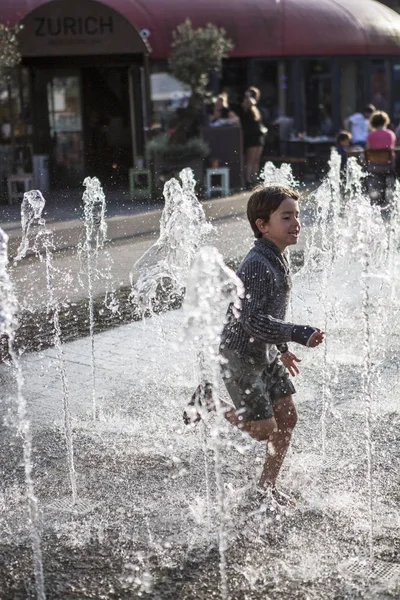 Amsterdam, The Netherlands, 13 September 2014, at West'ival, a free open air Cinema and culture festival on Mercatorplein, child having fun in the fountain