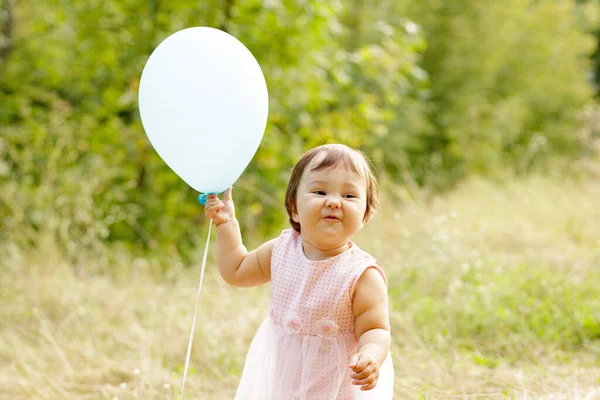 Cute Smiling Infant Reaches Light Balloon Fingers Mouth Top View — Stock Photo, Image