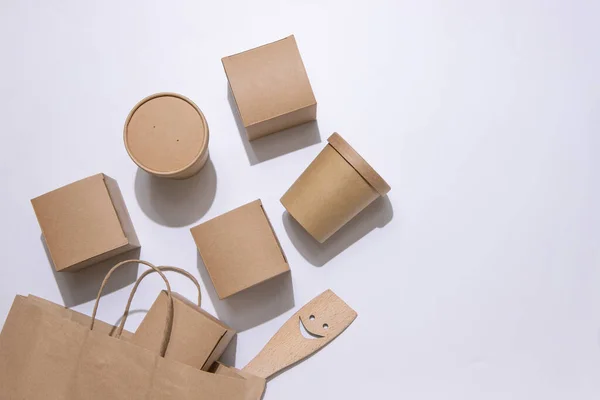 Cardboard containers and a bag for food, drinks and objects. White background. Isolate Top view. Copy space. Delivery concept, takeaway, craft packaging.