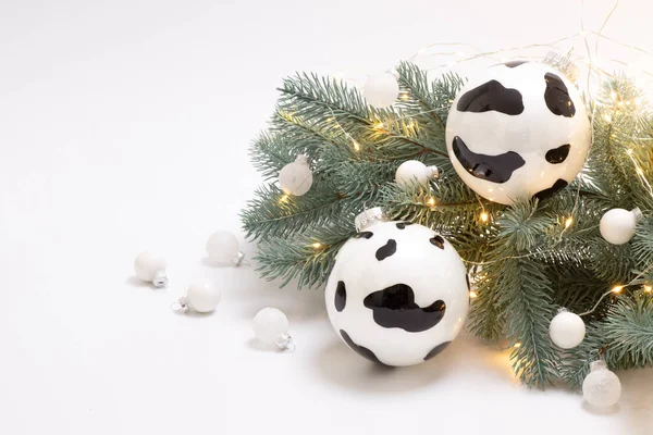 Noel ağacında çelenkli inek gibi bir Noel balosu. Beyaz arka plan. Mutlu bir tatil, kış, boğa konsepti yılı. Uzayı kopyala Yatay. 