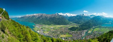 beautiful view of Interlaken town, Eiger, Monch and Jungfrau mountains and of Lake Thun and Lake Brienz from Two Lakes Bridge viewing platform on Harder Kulm, Switzerland clipart