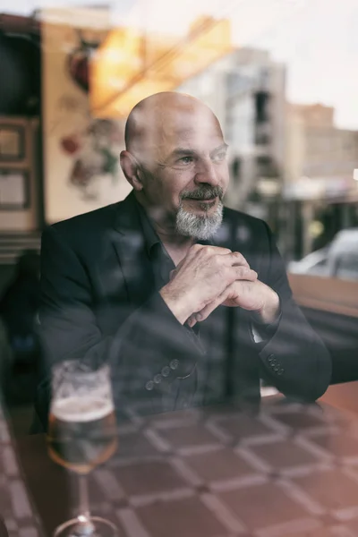 Mature man in a cafe enjoying a relaxing moment