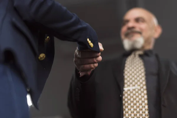 Senior man handshake to business woman