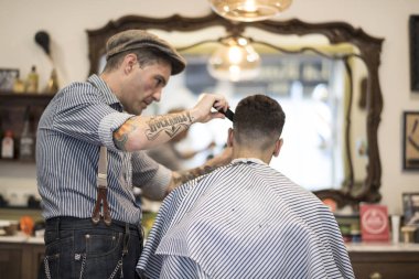 Barber shop, man cuts person hair clipart
