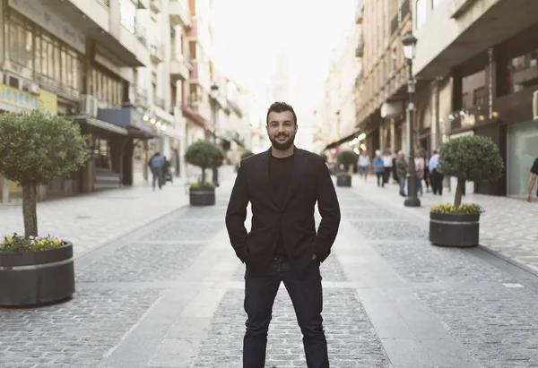 Cool man posing in the street looking at camera