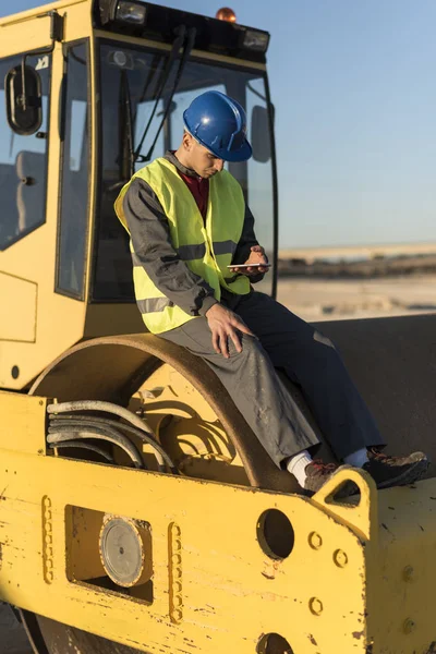 Construction worker revise excavator tire