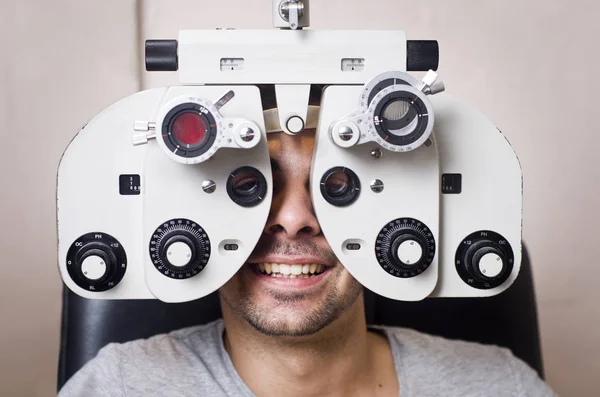 Young boy in an optical scans machine exams his vision and optometry