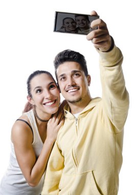 Young couple with smart phone taking selfie