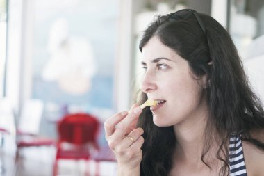 restoranda cips yiyen güzel esmer kadın