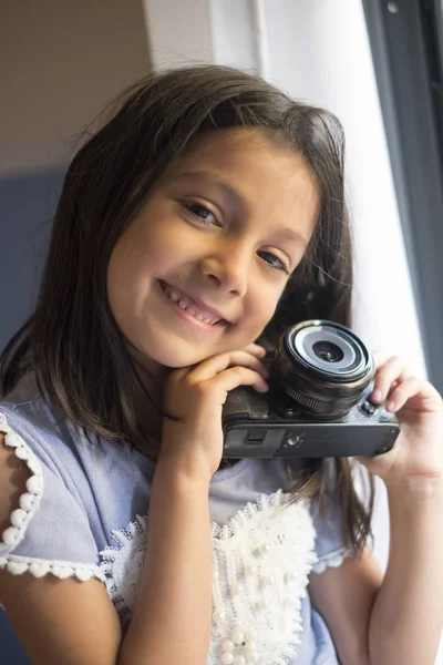 little girl posing with camera indoor