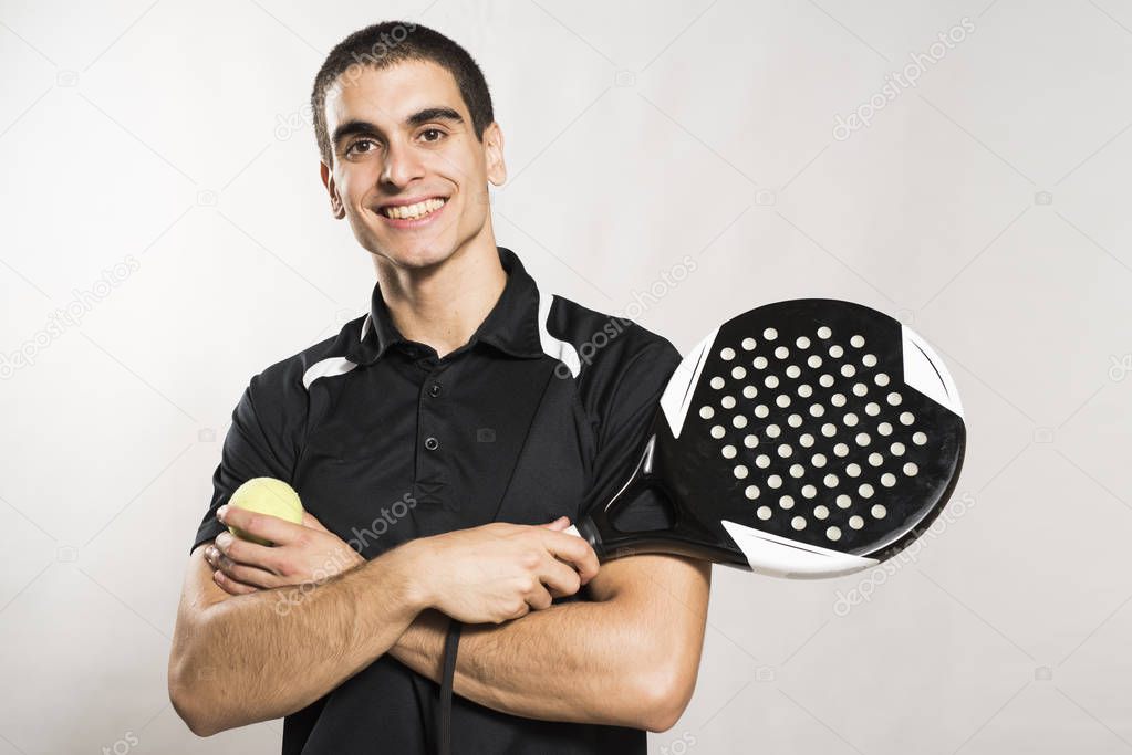 Paddle tennis player on white background posing