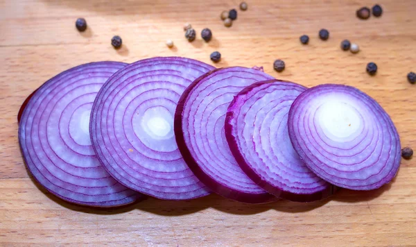Onion sliced rings on a wooden board
