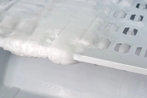 Ice in the freezer of the refrigerator. Repair, malfunction of the refrigerator.