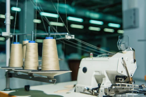 Coils of thread. Production of home textiles. Cotton colored threads. Weaving factory. Raw materials for clothing