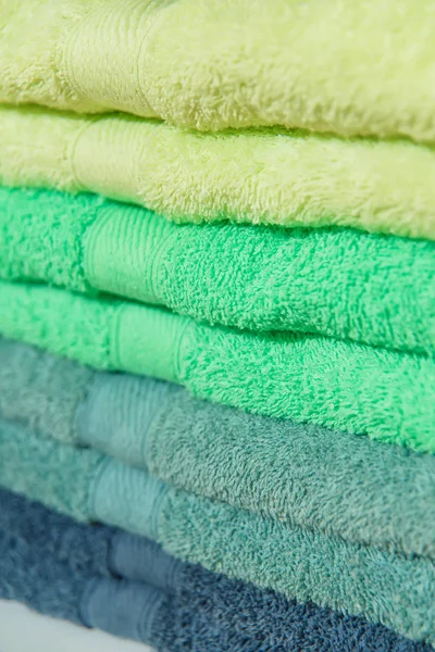 Color terry towels in the hotel. Dry and soft towels for the bathroom. Home textiles. Bathroom textiles