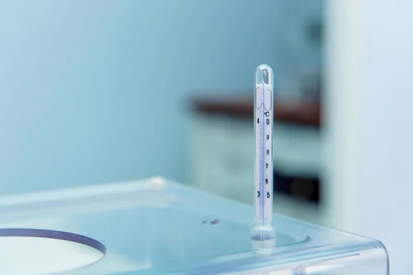 Thermometer in the laboratory. Measurement of ambient temperature with a thermometer. Laboratory tests.