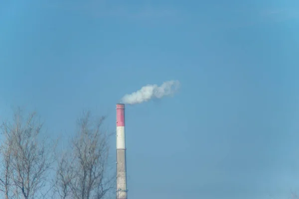 Pipe factory with smoke. Smoking pipe factory. Environmental pollution. Air emissions by the plant.