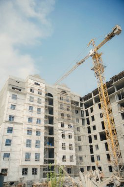 Çok katlı konut binası inşaatı. sarı vinç inşaat arka plan üzerinde. özel ekipman inşaat sahasında. bitmemiş monolitik evi.