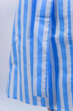 Pamuk bornoz. Tekstil. Beyaz çizgili mavi bornoz. Kumaş dokusu. Pamuk. Bornoz kemer insanlar. Otel ve otel için giyim. Kadın. Sarı saçlı. Kol.