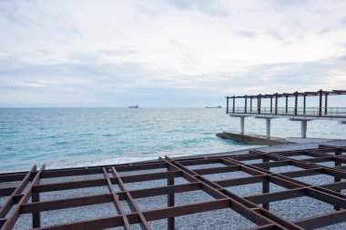 Metal yapılar sahilde. Gölgelik. Karadeniz. Kayalık plaj. Su yüzeyi. Massandra plaj. Yalta. Kırım'dinlenme. Plaj boyunca yürümek.