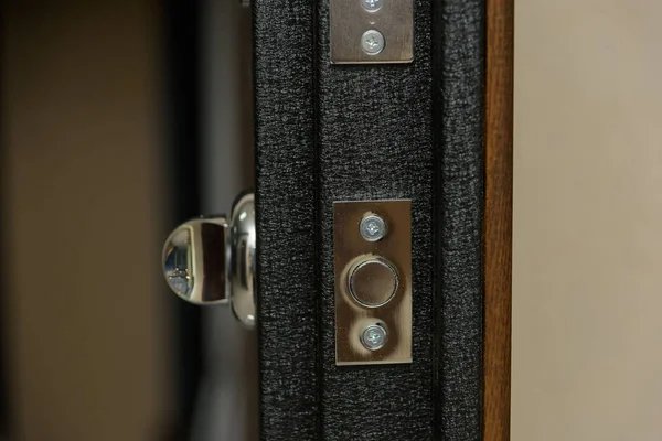 The door is sheathed in wood. Wood carving. Internal lock design. Keyhole. Metal door handle. Anti-burglar armored door. Metal doors. The design of the door. Peephole.