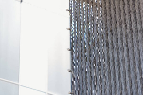 Corrugated aluminum. Finish exterior facades aluminum. Shopping center. Bulbs for night lighting. Metal panels for cladding. Ventilated facade. Yellow aluminum panel.