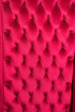 Pink velvet chair with rivets. Upholstered furniture in the room. Texture of the chair with rivets. Velvet fabric. clipart