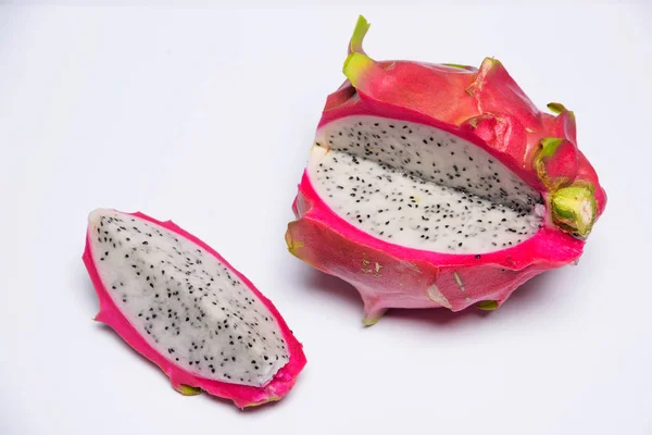 Exotic fruit. Dragon fruit. Red pitaya. Pitahaya pulp with black seeds. Sweet pitaya on white background. Cut dragon fruit. Pitaya with white flesh.