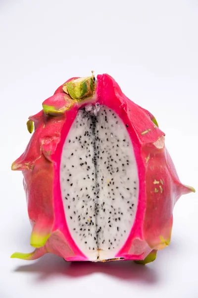 Exotic fruit. Dragon fruit. Red pitaya. Pitahaya pulp with black seeds. Sweet pitaya on white background. Cut dragon fruit. Pitaya with white flesh.