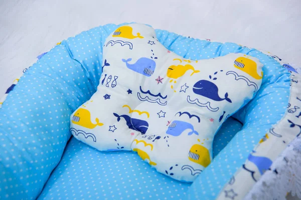 Orthopedic pillows for newborns. Envelope for the newborn. Pillows bumpers. Set of pillows for a baby cot. The texture of the fabric.  Mattresses and envelopes for newborns. Orthopedic pillow.