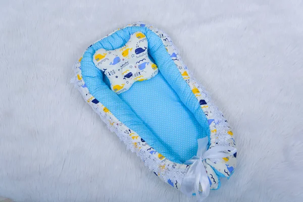 Orthopedic pillows for newborns. Envelope for the newborn. Pillows bumpers. Set of pillows for a baby cot. The texture of the fabric.  Mattresses and envelopes for newborns. Orthopedic pillow.