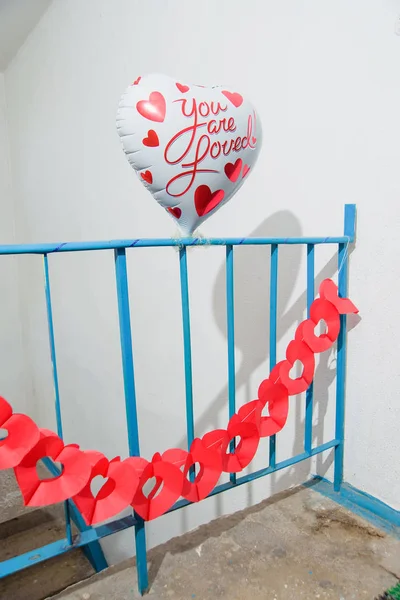 Wedding. The decoration of the entrance of the balls. Decor. Colorful helium balloons. Foil balloons. Paper garlands. The staircase is decorated with beads.