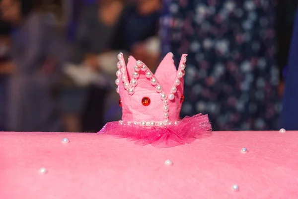 Decorative pink cardboard house with a crown. Gifts Packed in transparent paper with red ribbon. The event at the restaurant.