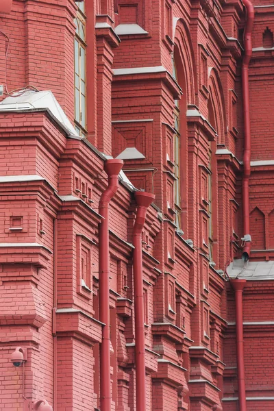 The texture of the house of red brick in Moscow. An ancient building in Russia. The facade of buildings in the classic Russian style. Classic architecture of Europe