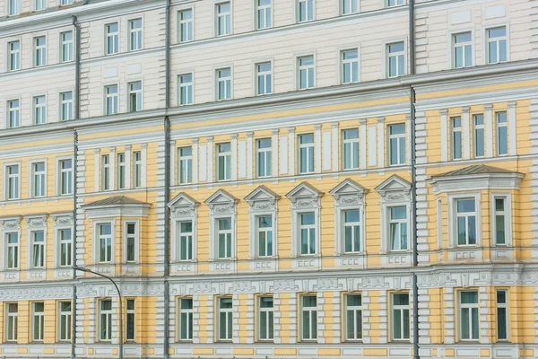 The texture of the house in Moscow. High-rise building in Russia. The facade of buildings in the classical style. Classic architecture of Europe